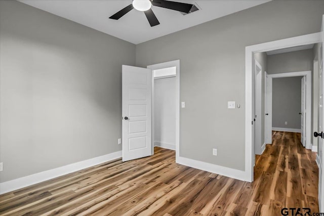 1002 E Main St, Whitehouse, TX 75791 - unfurnished bedroom with wood finished floors, baseboards, and a ceiling fan