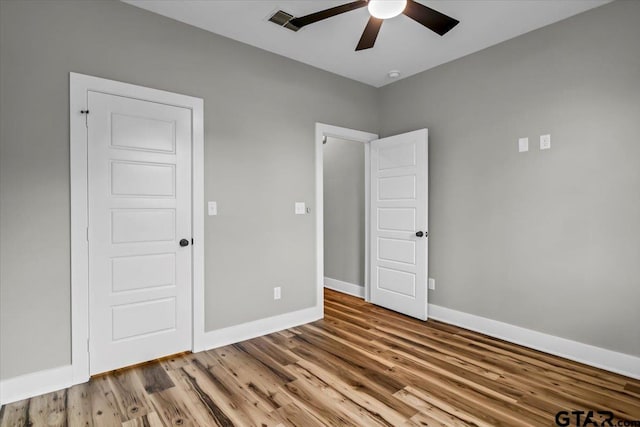 1002 E Main St, Whitehouse, TX 75791 - unfurnished bedroom featuring baseboards, wood finished floors, and ceiling fan