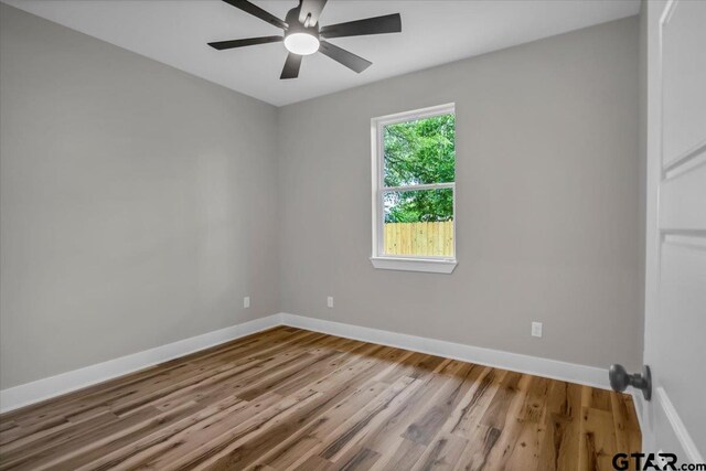 1002 E Main St, Whitehouse, TX 75791 - unfurnished room with wood finished floors, baseboards, and ceiling fan