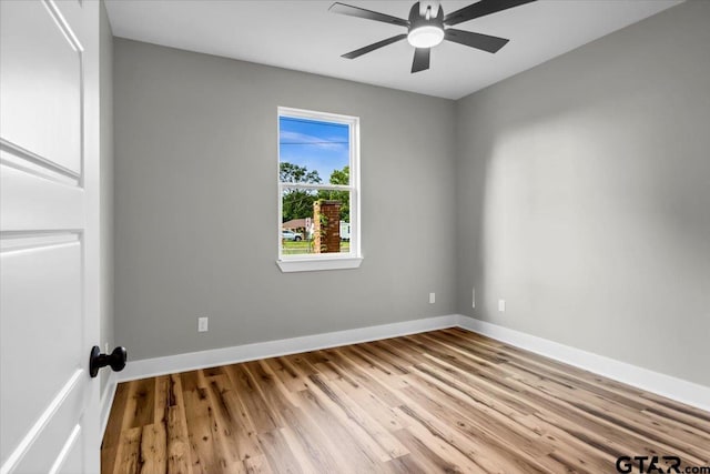 1002 E Main St, Whitehouse, TX 75791 - unfurnished room with wood finished floors, a ceiling fan, and baseboards