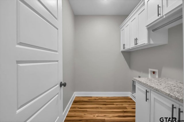 1002 E Main St, Whitehouse, TX 75791 - laundry room with baseboards, wood finished floors, hookup for a washing machine, and cabinet space