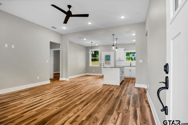 1002 E Main St, Whitehouse, TX 75791 - unfurnished living room featuring a ceiling fan, light wood finished floors, a sink, baseboards, and recessed lighting