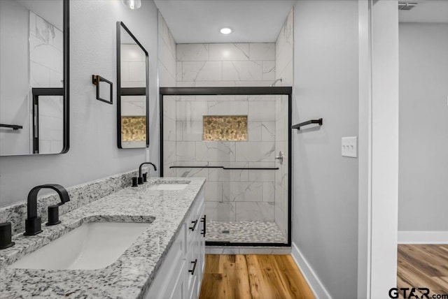 1002 E Main St, Whitehouse, TX 75791 - full bath with wood finished floors, a shower stall, double vanity, baseboards, and recessed lighting