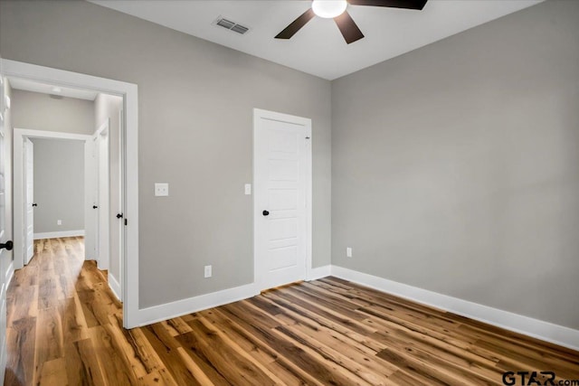1002 E Main St, Whitehouse, TX 75791 - unfurnished bedroom with wood finished floors, baseboards, and a ceiling fan