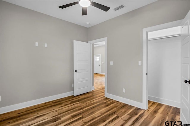 1002 E Main St, Whitehouse, TX 75791 - unfurnished bedroom with wood finished floors, baseboards, a ceiling fan, and a closet