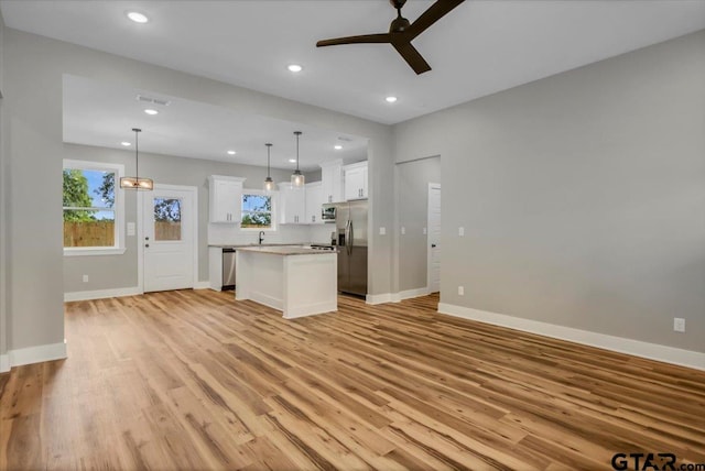 1002 E Main St, Whitehouse, TX 75791 - unfurnished living room with ceiling fan, light wood-type flooring, plenty of natural light, baseboards, and recessed lighting