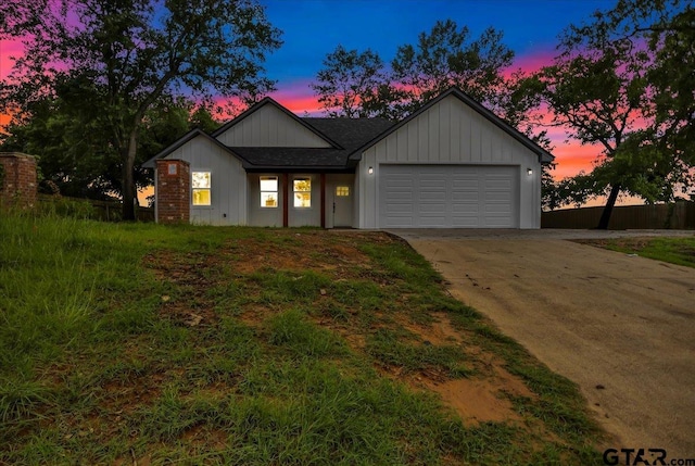 1002 E Main St, Whitehouse, TX 75791 - view of front of house with an attached garage, concrete driveway, roof with shingles, and board and batten siding