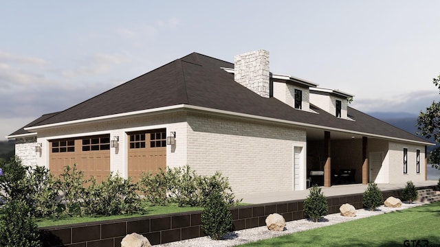 view of home's exterior with brick siding, a chimney, an attached garage, and a lawn