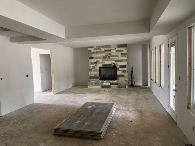 unfurnished living room with a fireplace and a raised ceiling