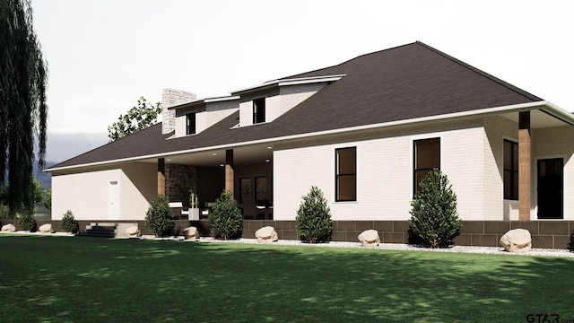 view of front of house with brick siding, a chimney, and a front yard