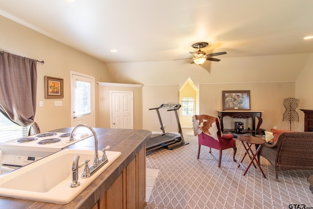 carpeted office featuring ceiling fan, sink, and vaulted ceiling