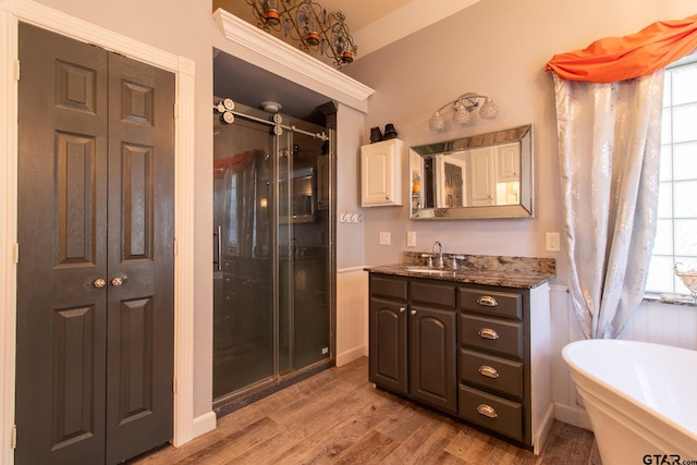 bathroom featuring vanity, hardwood / wood-style floors, crown molding, and separate shower and tub