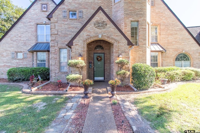 english style home with a front yard