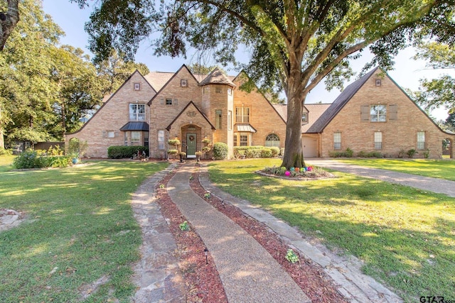 13510 White Tail Dr, Tyler, TX 75707 - english style home with brick siding, a front lawn, and driveway