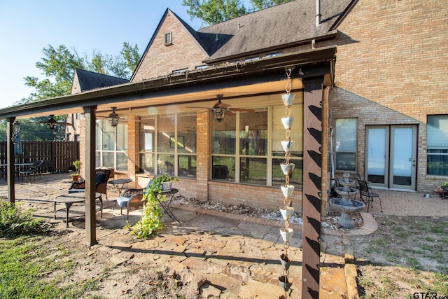 back of property featuring ceiling fan and a patio area