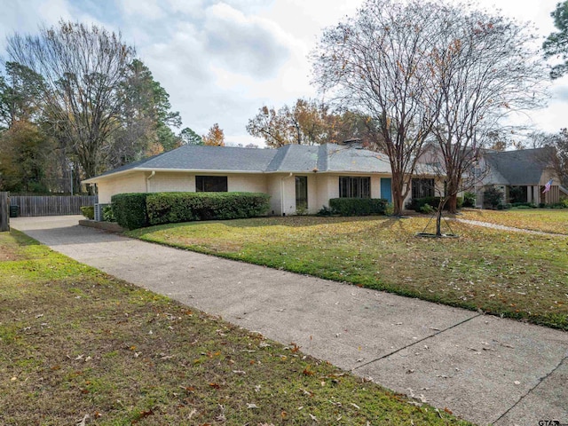 4010 Silverwood Dr, Tyler, TX 75701 - ranch-style house with a chimney and brick siding