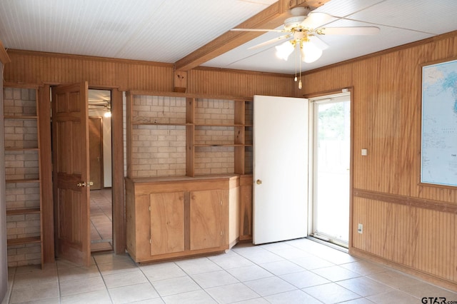 4010 Silverwood Dr, Tyler, TX 75701 - spare room with wood walls, ceiling fan, and light tile patterned flooring