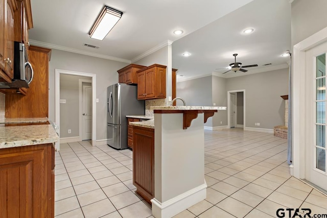 kitchen with decorative backsplash, a kitchen breakfast bar, kitchen peninsula, ornamental molding, and stainless steel appliances