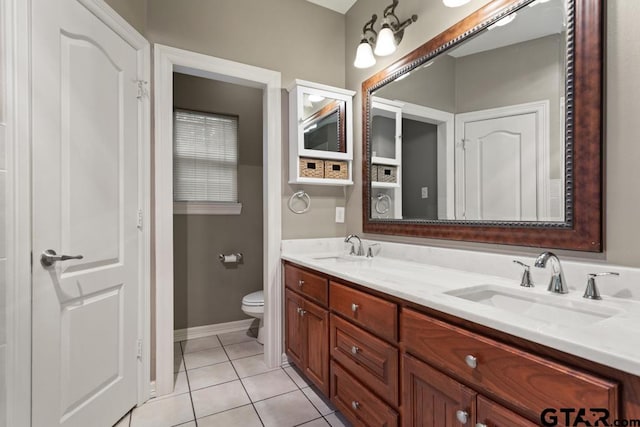 bathroom featuring toilet, vanity, and tile patterned floors