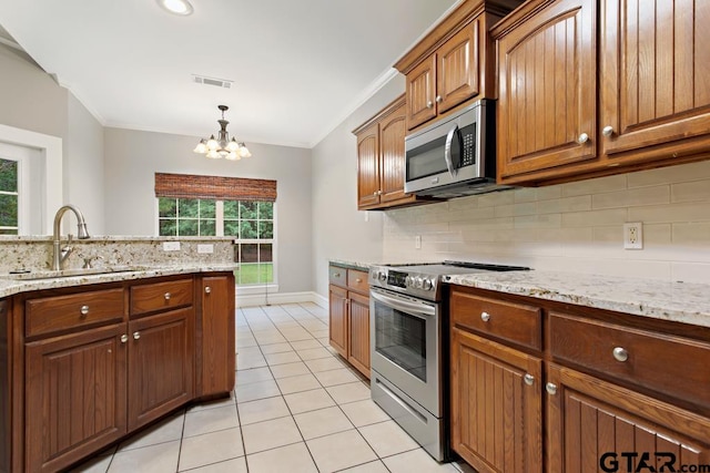 kitchen featuring sink, stainless steel appliances, light stone counters, crown molding, and a chandelier