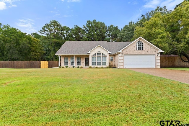 ranch-style home featuring a garage and a front lawn