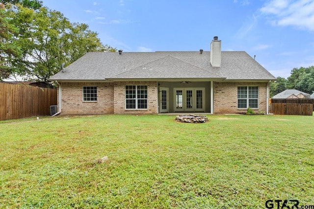 rear view of house with a yard and french doors