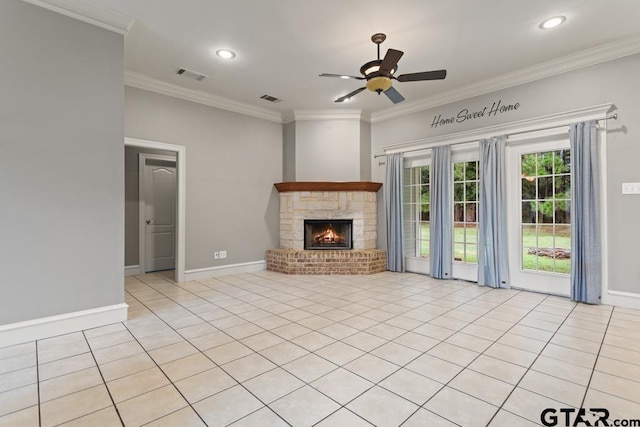 unfurnished living room with ceiling fan, light tile patterned flooring, a stone fireplace, and ornamental molding