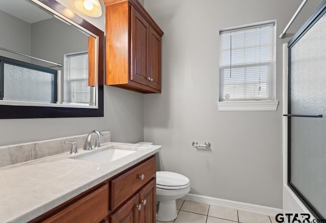 full bathroom featuring tile patterned floors, vanity, combined bath / shower with glass door, and toilet