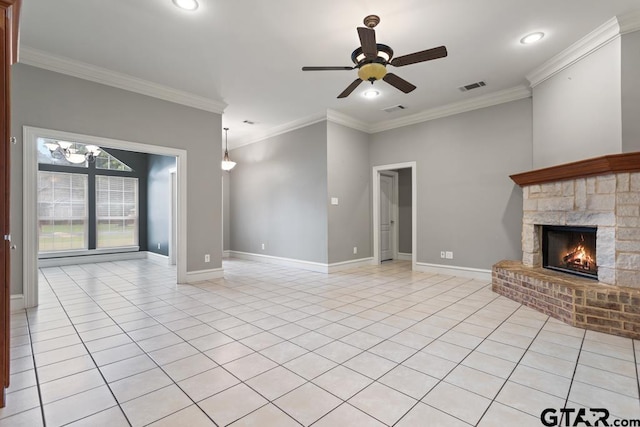 unfurnished living room with a fireplace, ceiling fan, crown molding, and light tile patterned flooring