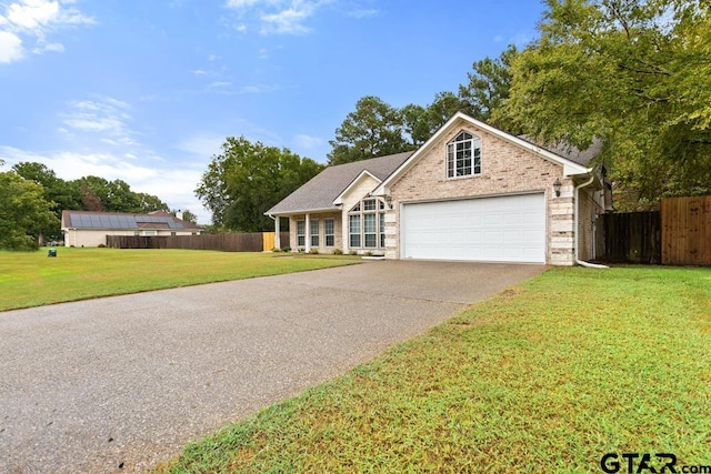 view of front facade featuring a front yard and a garage