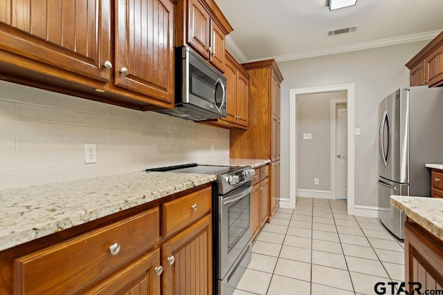 kitchen featuring stainless steel appliances, tasteful backsplash, crown molding, and light tile patterned flooring