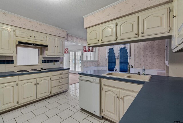 kitchen with french doors, a textured ceiling, sink, white appliances, and cream cabinetry