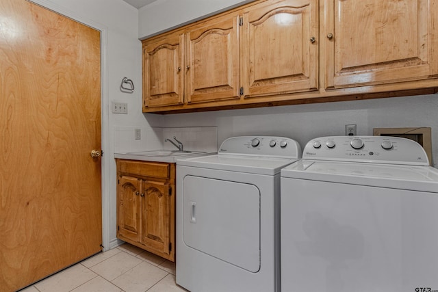 clothes washing area featuring separate washer and dryer, cabinets, sink, and light tile patterned floors