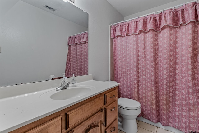 bathroom with vanity, tile patterned floors, and toilet