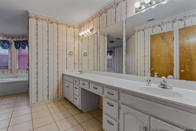 bathroom with tile patterned flooring, vanity, and a tub