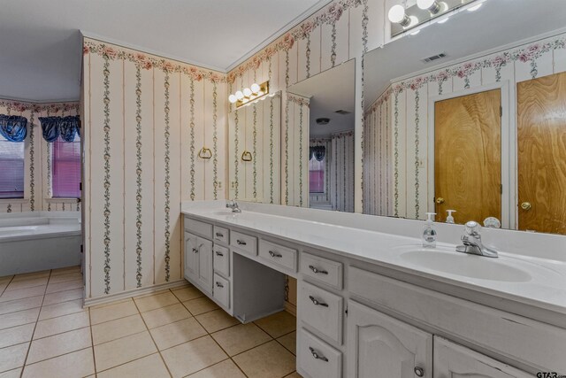 bathroom with tile patterned flooring, vanity, and a tub