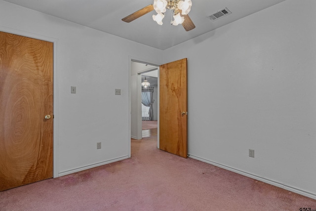 unfurnished bedroom featuring light colored carpet and ceiling fan