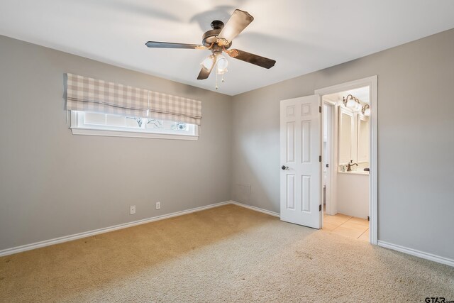 7117 Holly Square Ct, Tyler, TX 75703 - unfurnished bedroom with carpet flooring, baseboards, a ceiling fan, and connected bathroom