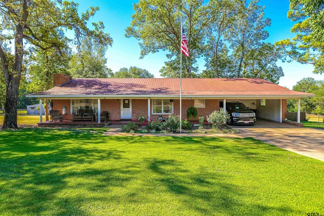 ranch-style home featuring covered porch, a front lawn, and a carport