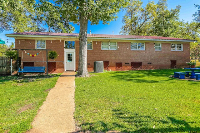 exterior space with cooling unit and a yard