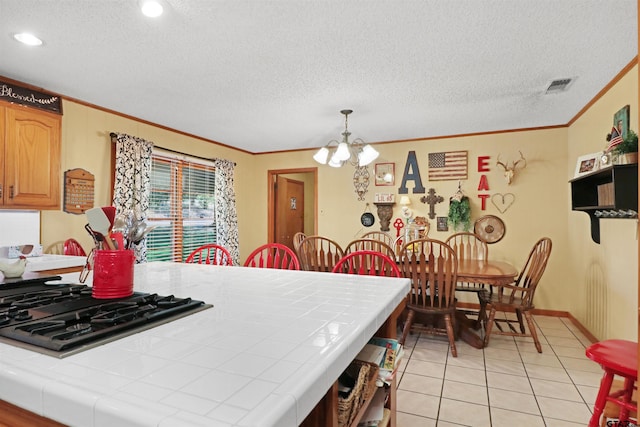 kitchen featuring hanging light fixtures, tile countertops, light tile patterned floors, and a notable chandelier