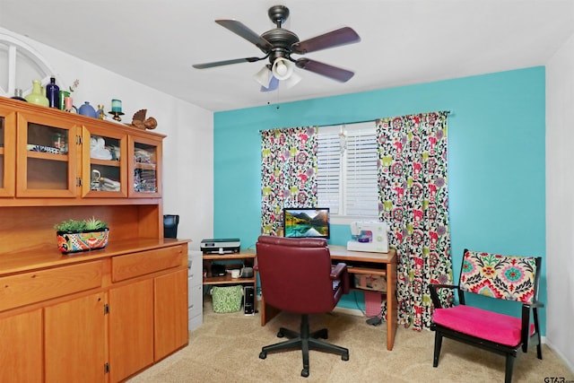 carpeted home office with ceiling fan