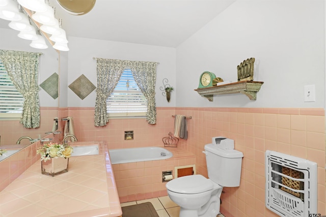 bathroom featuring toilet, a tub, tile patterned floors, tile walls, and heating unit