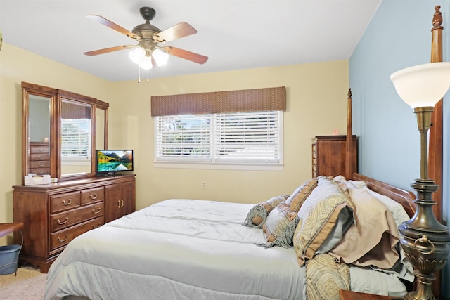 bedroom featuring light carpet, multiple windows, and ceiling fan