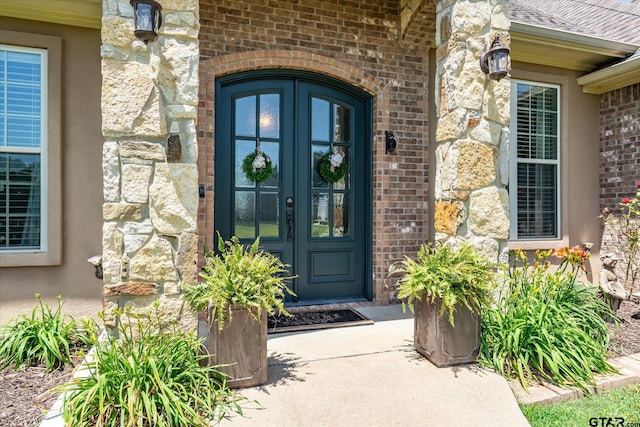 301 Zambezi Ln, Bullard, TX 75757 - view of exterior entry featuring french doors, stone siding, brick siding, and a shingled roof