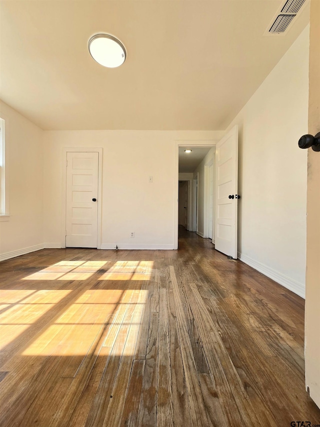 unfurnished room with hardwood / wood-style flooring