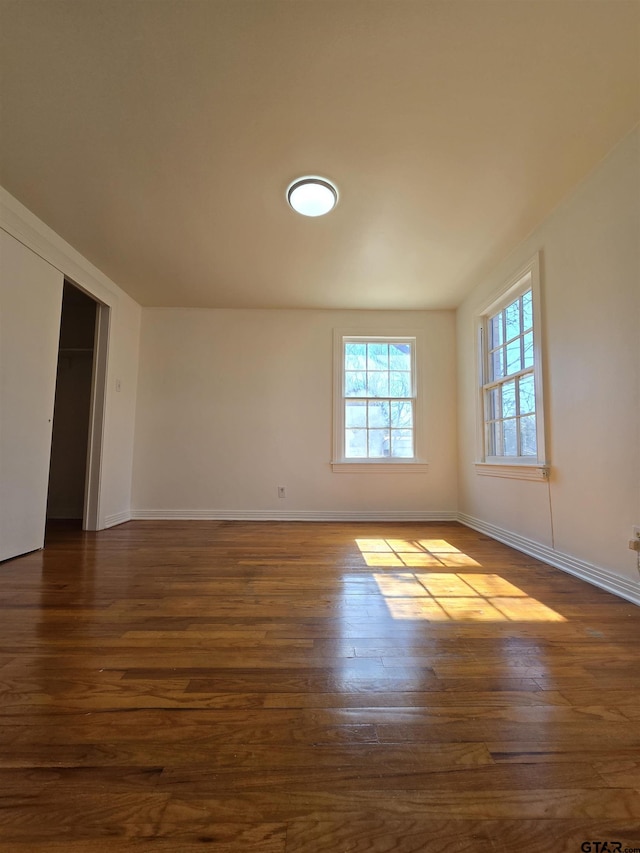 spare room with dark hardwood / wood-style flooring