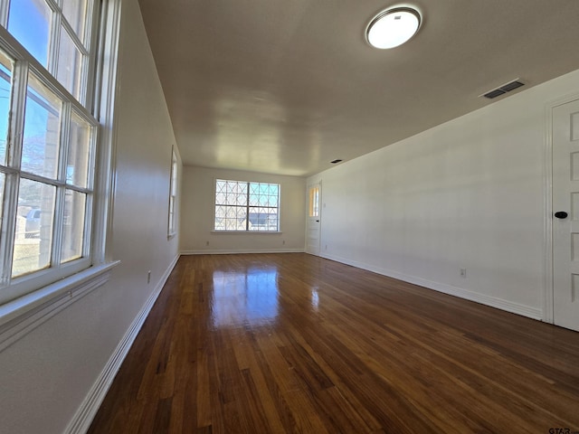 unfurnished room with dark hardwood / wood-style floors