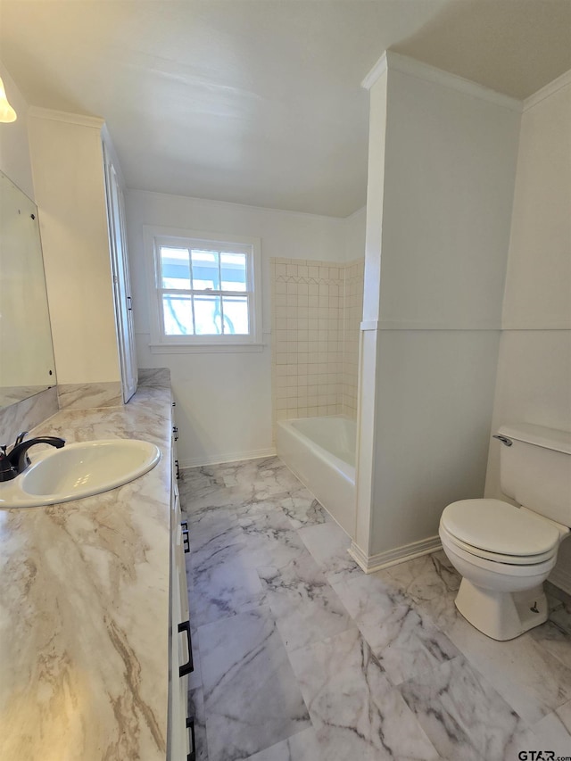 bathroom with toilet, a bath, and vanity