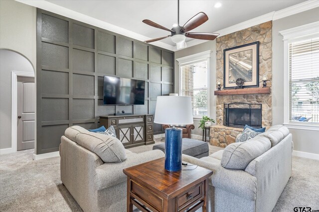 301 Zambezi Ln, Bullard, TX 75757 - living area with a stone fireplace, ceiling fan, light carpet, crown molding, and a decorative wall